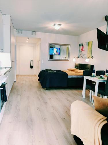 a bedroom with a bed and a living room at Joutjärven Studio Apartment in Lahti