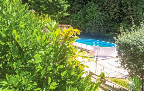 a swimming pool in the middle of a garden at Stunning Apartment In La Coquille in La Coquille