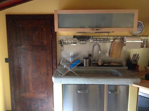a kitchen with a sink and a counter top at Mansarda Pescia in Pescia