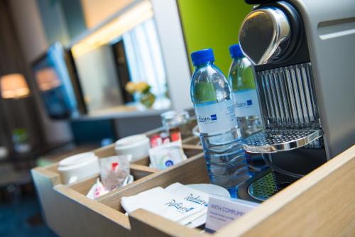 a wooden box with a hair dryer and a bottle of water at Radisson Blu Hotel & Residence Maputo in Maputo