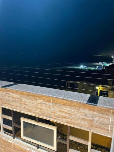 a view from the roof of a building at night at Alzohour Family condo with panoramic sea view in Alexandria
