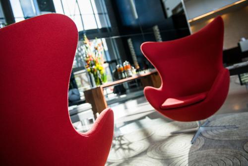 a pair of red chairs sitting in a room at Radisson Blu Hotel & Residence Maputo in Maputo