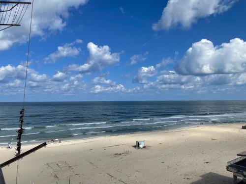 a beach with the ocean on a cloudy day at Alzohour Family condo with panoramic sea view in Alexandria
