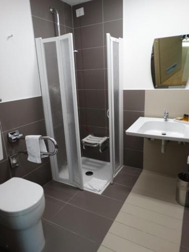 a bathroom with a shower and a toilet and a sink at Hotel Il Cantico St. Peter in Rome