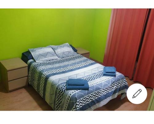 a bedroom with a bed with blue and green walls at Barcelona Centric in Barcelona