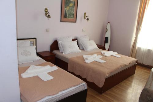 two beds in a room with towels on them at 21 На удачу in Rustavi