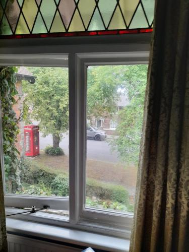 a window with a view of a red telephone box at Fern Cottage in Scalby