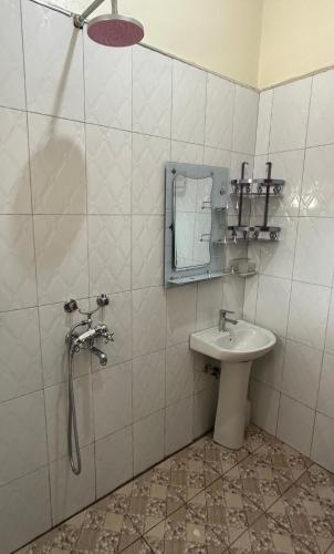 a bathroom with a shower and a sink at Makanga Hill Suites in Kabale