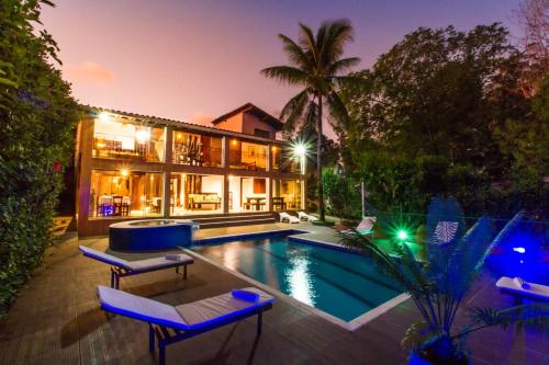 an exterior view of a house with a swimming pool at Alto do Aeroporto Hotel in Porto Seguro