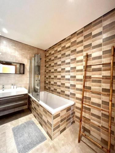 a bathroom with a tub and a sink at Funtastic Villa With Pool in Albufeira