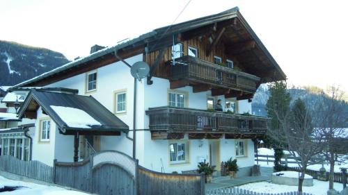 a large white building with wooden balconies on it at Apartment Graber in Krimml