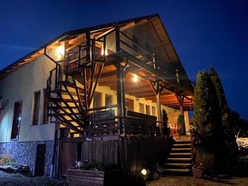 a house with stairs leading up to it at night at Casa Genesini in Miercurea-Ciuc