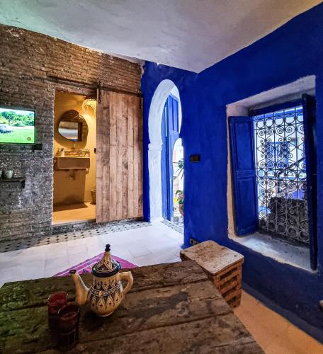 a room with blue walls and a blue door at Casa Amina in Chefchaouene