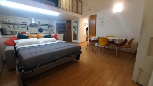 a bedroom with a bed and a table and chairs at White Home Quartieri Spagnoli in Naples
