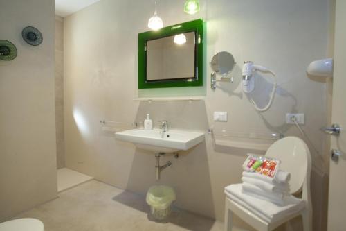 a bathroom with a sink and a mirror and a toilet at Suite in Baveno