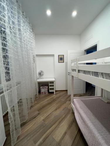 a bedroom with a bunk bed and a desk at Casa D'Aria in Savona