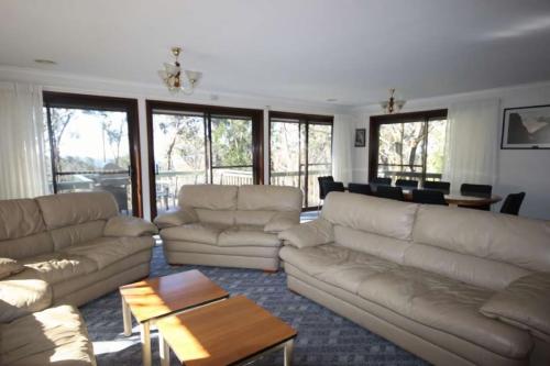 a living room with couches and a coffee table at Hearthstone in Blackheath