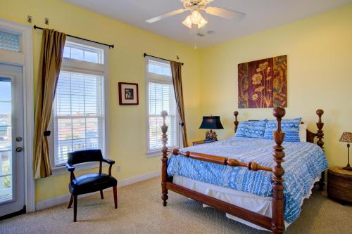 a bedroom with a bed and a chair and windows at My Turn at Surf City in Surf City