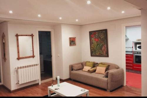 a living room with a couch and a table at Apartamento en el centro de OVIEDO in Oviedo