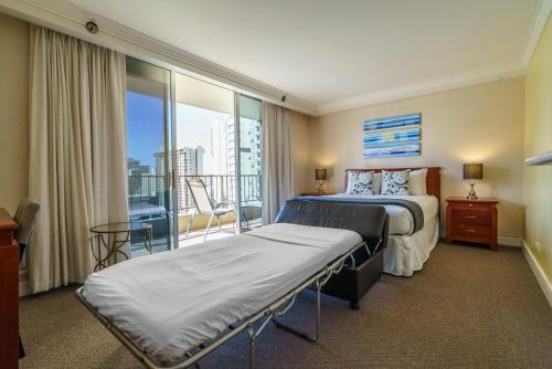 a hotel room with a bed and a balcony at Studio Unit at the Royal Garden, in Waikiki ワイキキ・ロイヤルガーデン in Honolulu