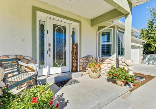 a front porch of a home with potted plants at Play & Gather in Luxury,Pets too! Close to it Everything! in Orem