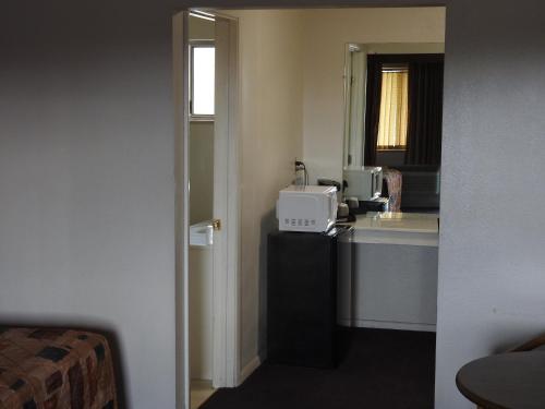 a hotel room with a desk with a computer on it at Downtown Inn in Albuquerque