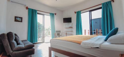 a bedroom with a bed and a large window at Ade Hotel Bacalar in Bacalar