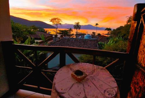 a view of a sunset from a balcony at Pousada Aquarela do Mar in Abraão