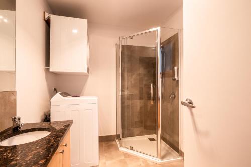 y baño con ducha y lavamanos. en Freycinet Stone Studio 8 - Sandstone, en Coles Bay