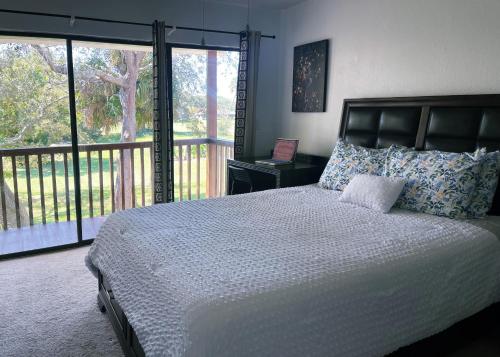 a bedroom with a large bed and a balcony at Hello Sunshine 321... Lift Off in Titusville