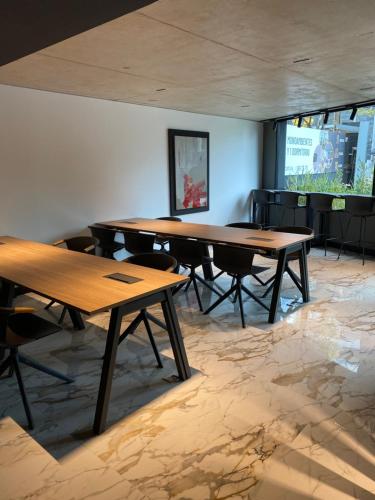 a group of tables in a room with chairs at EUGE Apart in Montevideo