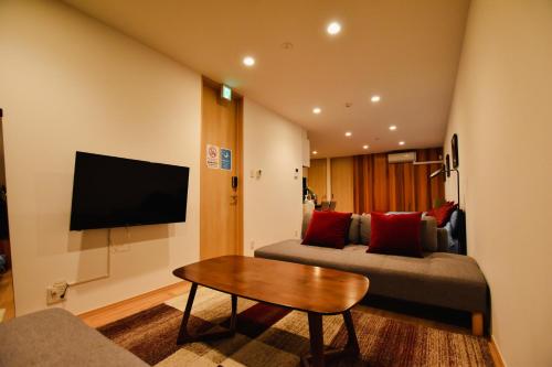 a living room with a couch and a table at PrimeRoom別府 GRANMAJESTA in Beppu