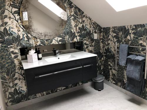 a bathroom with a sink and a mirror at KARANDA BnB in Rotorua