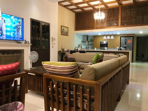 a living room with a couch and a tv at Kinmen Old Town Homestay in Jincheng