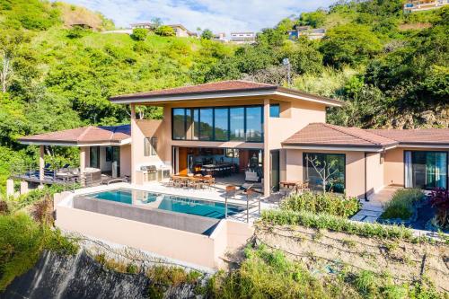 a house with a swimming pool and a waterfall at Casa Vistas At Mar Vista in Brasilito