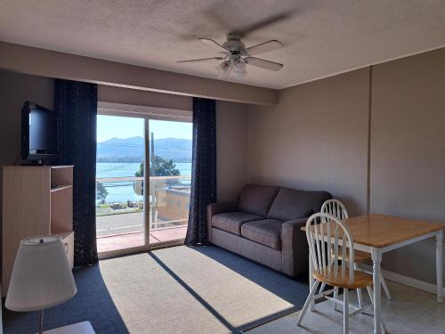 a living room with a couch and a table at Richter Pass Beach Resort in Osoyoos