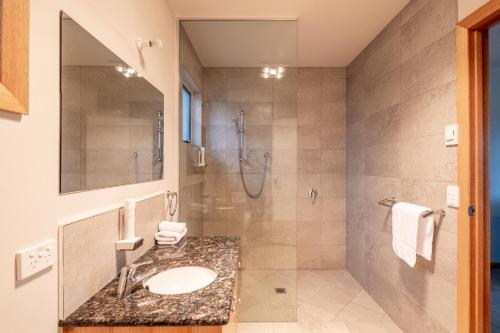 a bathroom with a sink and a shower at Freycinet Stone Studio 5 - Greystone in Coles Bay