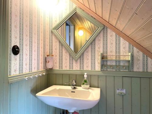 a bathroom with a sink and a mirror at Holiday home GRÄSTORP in Grästorp