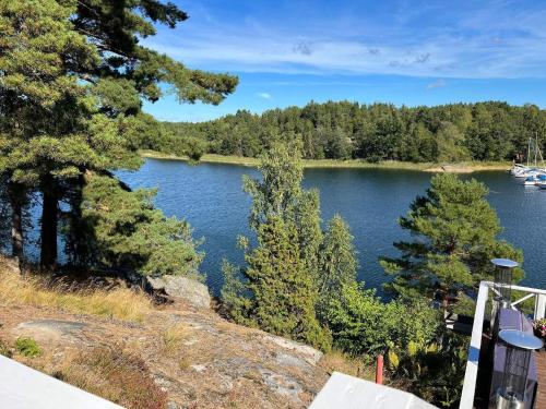 a view of a lake with trees in the background at 4 person holiday home in INGARÖ-By Traum in Grönskan