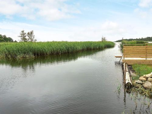 a river with a wooden dock on the side of it at 4 person holiday home in LYCKEBY-By Traum in Lyckeby