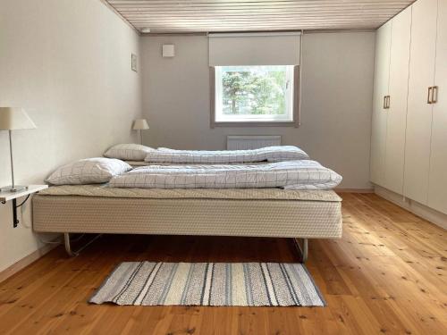 a bedroom with two beds and a window at 4 person holiday home in GAMLEBY-By Traum in Gamleby