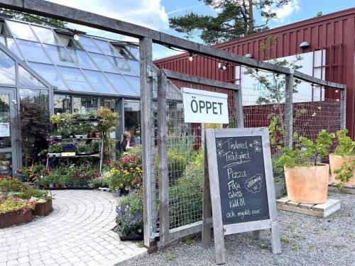 an open sign in front of a flower shop at 4 person holiday home in GAMLEBY-By Traum in Gamleby