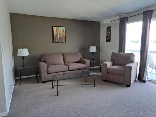 a living room with two couches and a coffee table at Richter Pass Beach Resort in Osoyoos