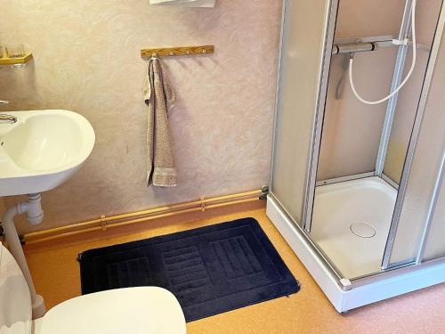 a small bathroom with a shower and a sink at 7 person holiday home in Hagby-By Traum in Hagby