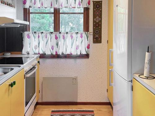 a kitchen with a white refrigerator and a window at 7 person holiday home in Hagby-By Traum in Hagby