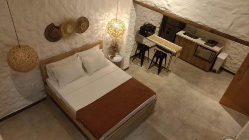 a bedroom with a bed and a kitchen with a table at La Casa de Nelly - Medellín in Medellín