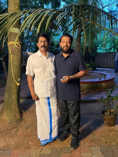 two men are standing next to each other at Marari Beach Villas in Mararikulam