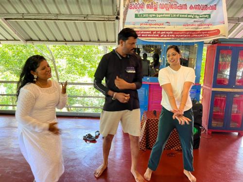 a group of three people standing in a dance floor at Marari Beach Villas in Mararikulam
