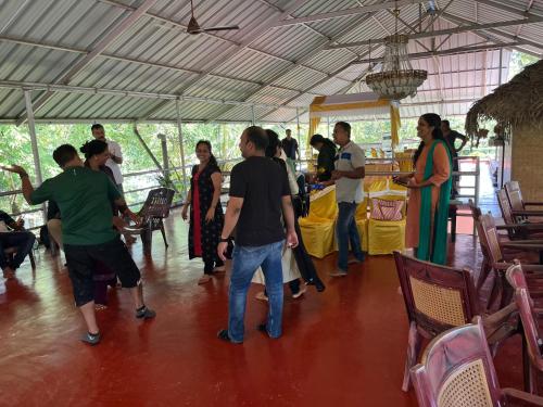 a group of people standing around in a tent at Marari Beach Villas in Mararikulam