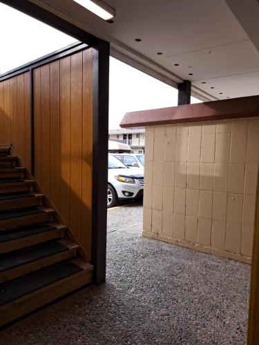 a stairway in a parking lot with a car parked at Richter Pass Beach Resort in Osoyoos